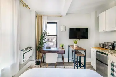a small kitchen with a table in a room at 73-1504 Newly Reno Studio UWS Doorman Gym Laundry in New York