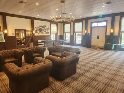 a large lobby with couches and chairs in a room at Moselem Springs Golf Club in Kutztown