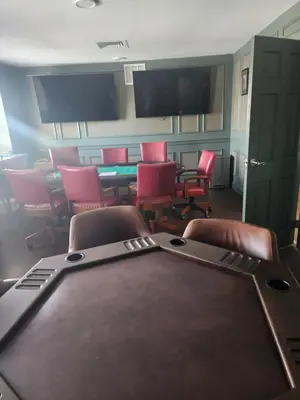 a conference room with chairs and a table and a tv at Moselem Springs Golf Club in Kutztown