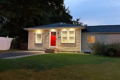 a small house with a red door in a yard at Lovely private home in a serene neighborhood in Totowa