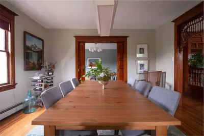 a dining room with a wooden table and chairs at Dancing Doe Estate - Delaware Valley Escape with Wood Stove and Hot Tub in Jeffersonville