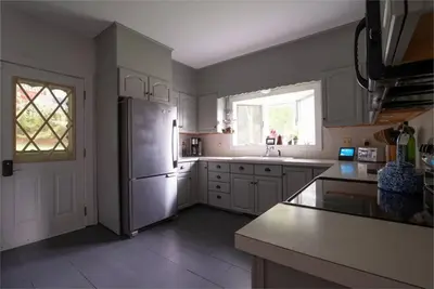 a kitchen with a stainless steel refrigerator and a window at Dancing Doe Estate - Delaware Valley Escape with Wood Stove and Hot Tub in Jeffersonville