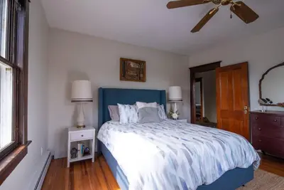 a bedroom with a bed and a ceiling fan at Dancing Doe Estate - Delaware Valley Escape with Wood Stove and Hot Tub in Jeffersonville