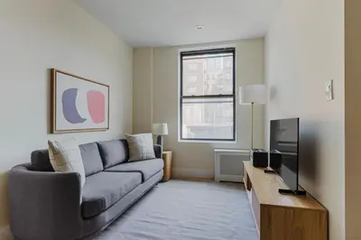 a living room with a couch and a tv at Blueground Greenpoint wd ac near ferry NYC-1538 in New York