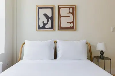 a bed with two white pillows in a bedroom at Blueground Greenpoint wd ac near ferry NYC-1538 in New York