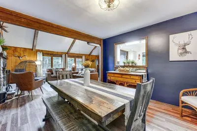a dining room with blue walls and a table at Pocono Lake Retreat Ski and Explore at Pine Loch! in Pocono Lake