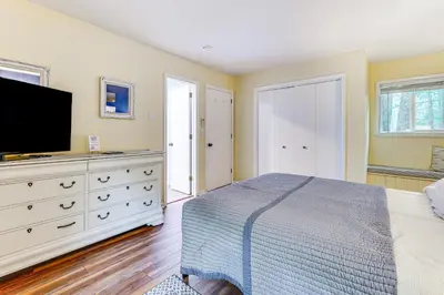 a bedroom with a bed and a flat screen tv at Pocono Lake Retreat Ski and Explore at Pine Loch! in Pocono Lake