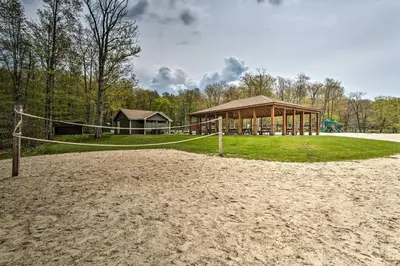 a volleyball court with a gazebo at Pocono Lake Retreat Ski and Explore at Pine Loch! in Pocono Lake