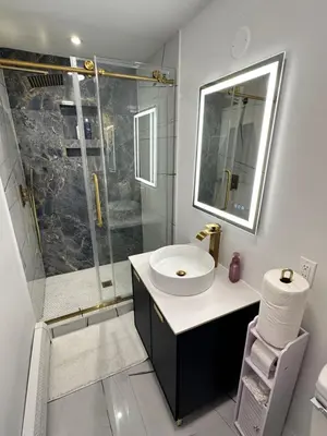 a white bathroom with a sink and a shower at Luxurious, newly renovated retreat in Springfield