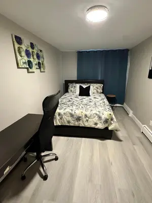 a bedroom with a bed and a desk and a chair at Luxurious, newly renovated retreat in Springfield