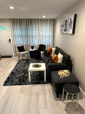 a living room with a couch and a table at Luxurious, newly renovated retreat in Springfield