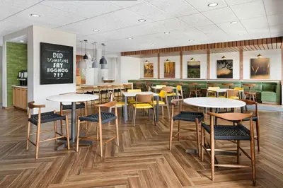 a dining room with tables and chairs in a restaurant at Fairfield by Marriott Inn & Suites Union in Union