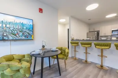 a living room with a table and two chairs at Opulence in Olive with Free Parking plus EV Plug, 2 BR 2 baths Suite, 5 beds and Sleeps 8 in Orange