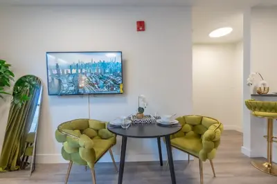 a dining room with a table and two chairs at Opulence in Olive with Free Parking plus EV Plug, 2 BR 2 baths Suite, 5 beds and Sleeps 8 in Orange