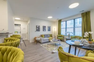 a living room with yellow chairs and a table at Opulence in Olive with Free Parking plus EV Plug, 2 BR 2 baths Suite, 5 beds and Sleeps 8 in Orange