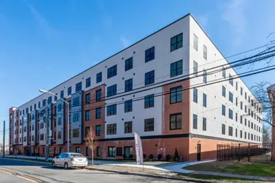 a building with a car parked in front of it at Opulence in Olive with Free Parking plus EV Plug, 2 BR 2 baths Suite, 5 beds and Sleeps 8 in Orange