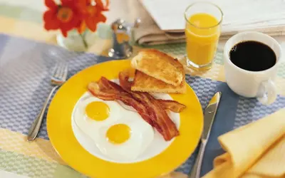 a plate of eggs and bacon and a cup of coffee at The Globe Inn in East Greenville