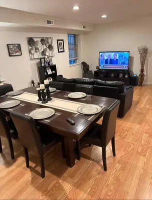 a living room with a table and a couch at Comfort Apartment Near Newark Airport in Newark