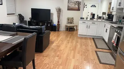 a living room with a couch and a kitchen at Comfort Apartment Near Newark Airport in Newark
