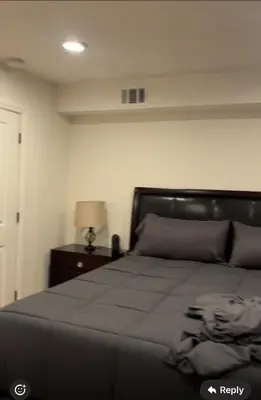 a bedroom with a bed and a table with a lamp at Comfort Apartment Near Newark Airport in Newark