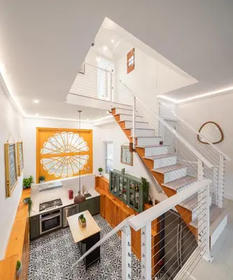 a staircase in a home with a kitchen and a living room at Modern Marvel at University City in Philadelphia