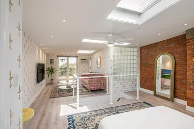 a bedroom with a white bed and a brick wall at Modern Marvel at University City in Philadelphia