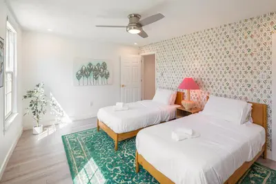 a bedroom with two beds and a rug at Modern Marvel at University City in Philadelphia