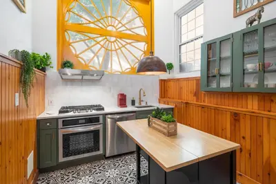 a kitchen with a stove and a table at Modern Marvel at University City in Philadelphia