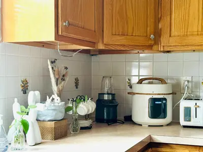 a kitchen counter with a coffee maker and other appliances at Sunny Apt by the park Mins away from midtown New York in Jersey City