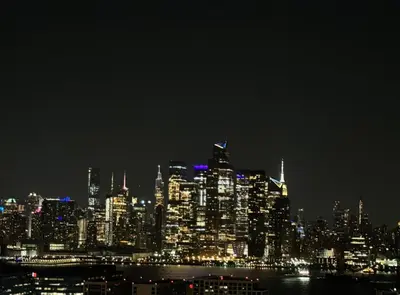 a nighttime view of a large city at night at Sunny Apt by the park Mins away from midtown New York in Jersey City