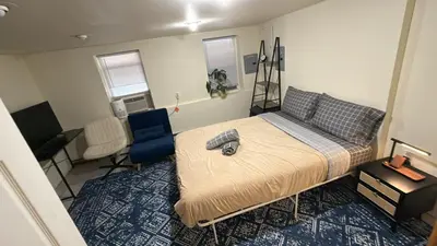 a bedroom with a bed and a desk and a chair at Sunny Apt by the park Mins away from midtown New York in Jersey City