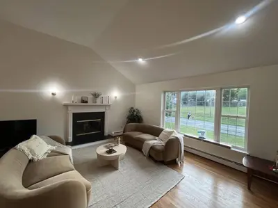 a living room with two couches and a fireplace at Cozy Beautiful Pondside Luxurious Retreat in Monroe