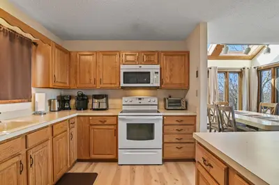 a kitchen with wooden cabinets and a white stove top oven at Pocono Mountain Village at Camelback 294 Overlook Way in Tannersville