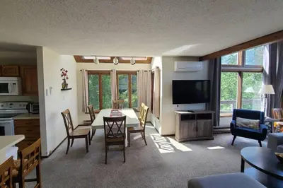 a kitchen and living room with a table and chairs at Pocono Mountain Village at Camelback 294 Overlook Way in Tannersville