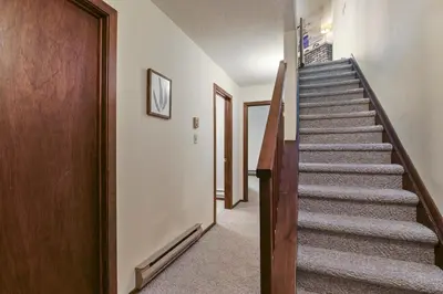 a staircase in a house with a wooden door at Pocono Mountain Village at Camelback 294 Overlook Way in Tannersville
