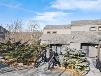a house with trees in front of it at Pocono Mountain Village at Camelback 294 Overlook Way in Tannersville