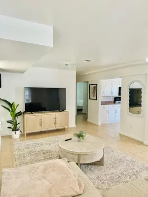 a living room with a large tv and a coffee table at Cozy Evergreen Apartment by Newark Airport in Newark