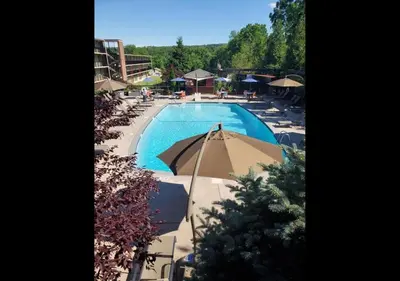 an overhead view of a swimming pool with umbrellas at New Hope Inn & Suites in New Hope