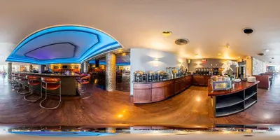 a restaurant with a bar with stools at New Hope Inn & Suites in New Hope