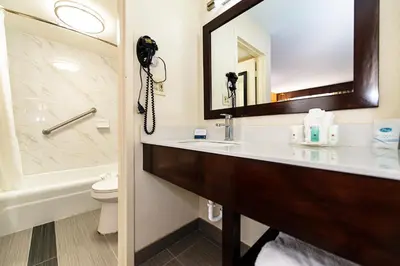 a bathroom with a sink and a toilet and a phone at New Hope Inn & Suites in New Hope