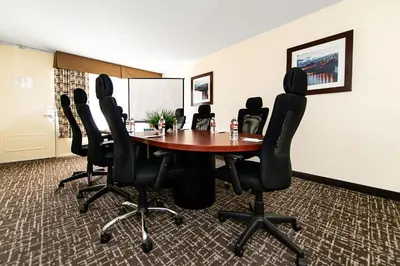 a conference room with a table and black chairs at New Hope Inn & Suites in New Hope