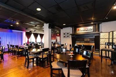 a restaurant with tables and chairs and a fireplace at New Hope Inn & Suites in New Hope