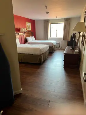 a hotel room with two beds and a window at Pottsville Hotel in Pottsville