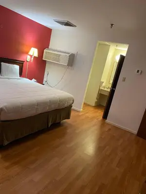 a bedroom with a bed and a red wall at Pottsville Hotel in Pottsville