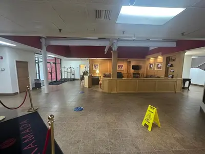 a large room with a yellow sign on the floor at Pottsville Hotel in Pottsville