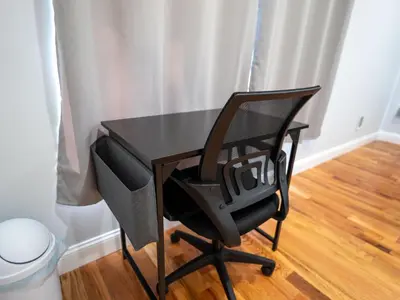 a black desk and a chair in a room at 4 New Apts - 3 Bed Apt 1st Floor & 3 Bed Apt 2nd Floor - 1 Bed Studio Apt Ground Floor & 1 Bed Studio Apt Ground Floor near Penn Station EWR Airport Beth Israel Hospital Manhattan NYC in East Orange