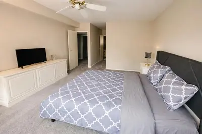 a bedroom with a bed and a flat screen tv at Comfort 2br2ba Monthly Discount in Elkins Park