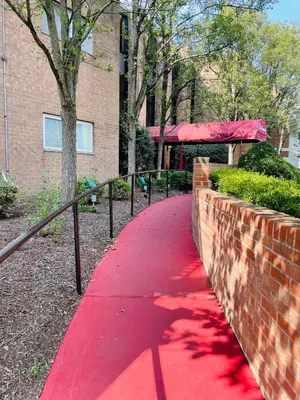 a red path in front of a brick building at Comfort 2br2ba Monthly Discount in Elkins Park