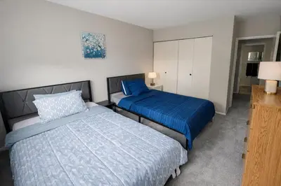 a bedroom with two beds and a dresser in it at Comfort 2br2ba Monthly Discount in Elkins Park