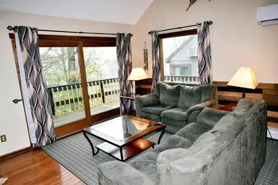 a living room with a couch and a table at Ski-In Ski-Out Camelback Village Townhouse - 100 YDS From The Mountain in Crescent Lake